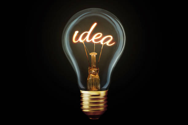 istock Creative light bulb with filament Idea glows on black background, concept. Think differently, creative idea. Marketing and generator of creative ideas. Creativity 2154421655