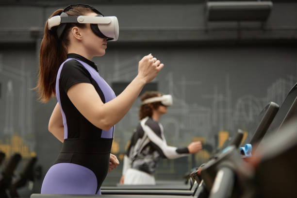istock Girl Running on Treadmill with VR Headset 2154423016