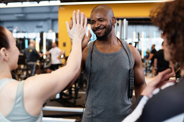 istock Smiling Black Fitness Coach High Five with Client 2154423072