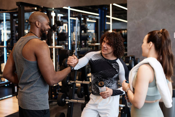 istock Group of People in Gym Shaking Hands 2154423079