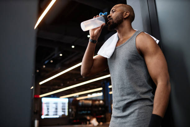 istock Muscular Black man drinking water in gym 2154423092