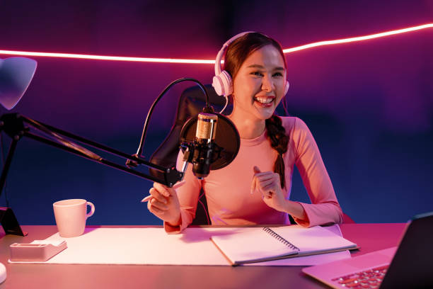 istock Smiling creative young beautiful Asian influencer talking in channel. Stratagem. 2154425448