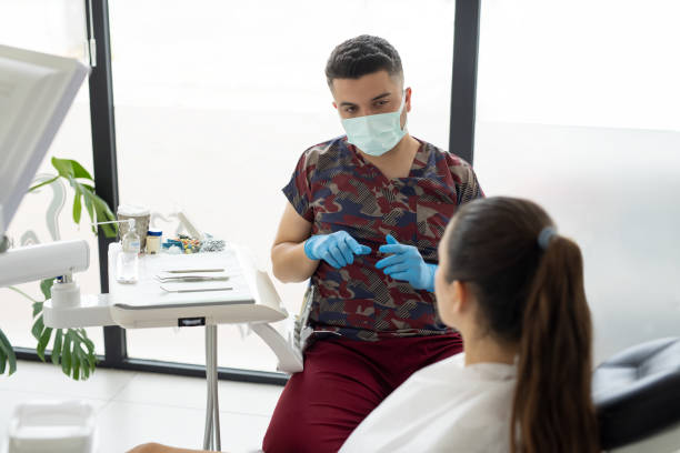 istock Dentist discussing with female patient 2154425580