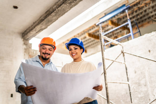 istock Home ownership talking and looking the blueprint in their house under construction 2154426481