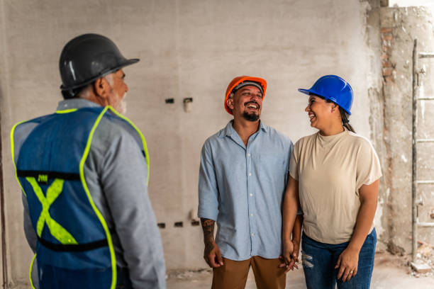 istock Couple talking with engineer in their house under construction 2154426490