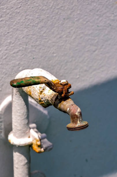 istock A rusty faucet is attached to a white pipe 2154427117