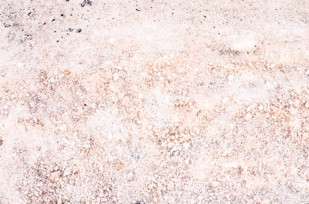 A dirty, rocky surface with a few small rocks scattered about. The surface is covered in dirt and he is in need of cleaning