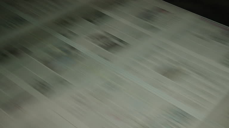 Newspaper on a print office line, modern technology.. 4K.