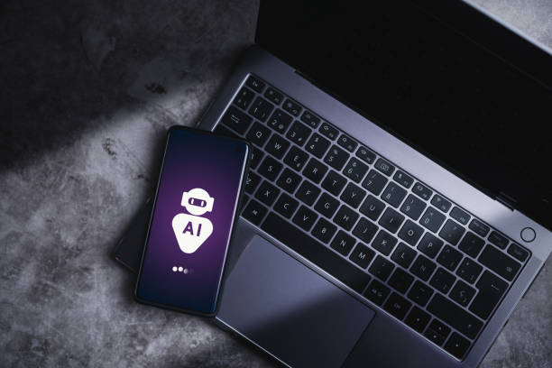istock Smartphone laying on laptop displaying virtual chat with AI. 2154427366