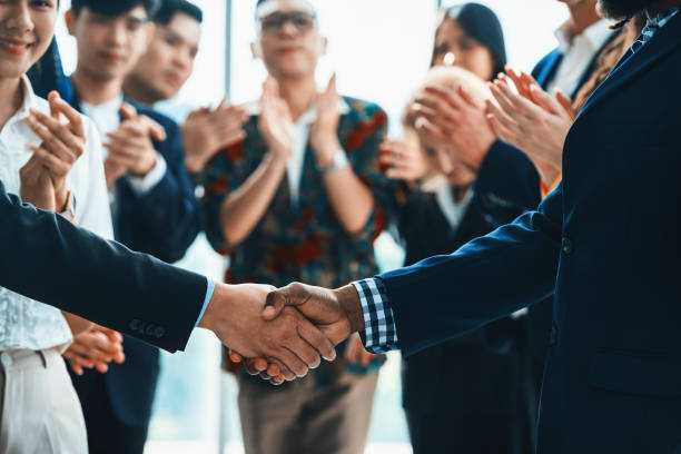 istock Cropped image of smart businessmen shaking hand, making agreement. Intellectual. 2154427399