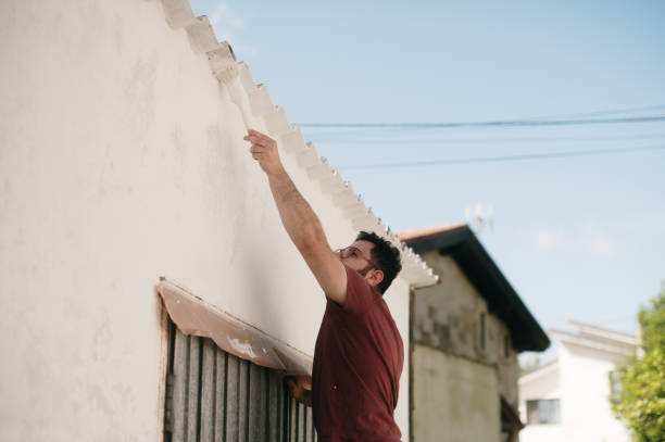 istock Man painting an exterior wall 2154428767