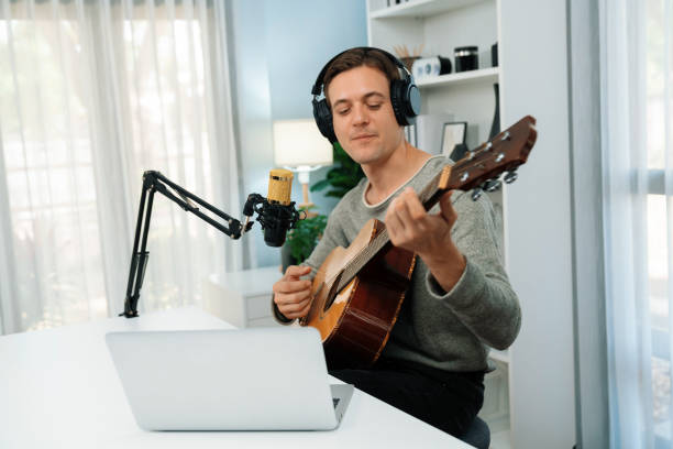 istock Singer with smile face on social media, playing guitar along singing. Pecuniary. 2154430241