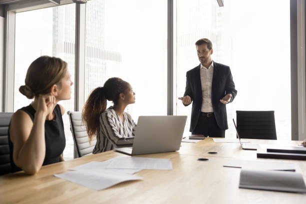 istock Male business leader talking to diverse team on briefing 2154430713