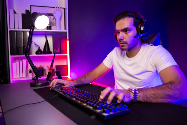 istock Serious face streamer concentrating gaming player trying to pass level. Surmise. 2154432319
