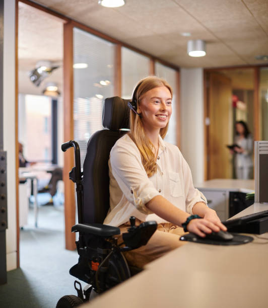 istock young disabled woman working at her desk in an office 2154432555