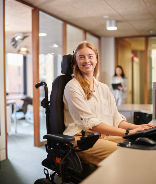 istock young disabled woman working at her desk in an office 2154432792