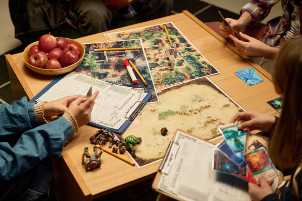 istock Kids looking through board game cards 2154432804