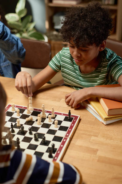 istock Cute boy thinking of next pawn move 2154432830