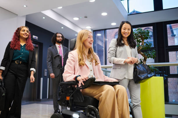 istock young woman with disability on her way to work with friends 2154432865