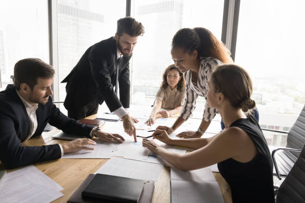 istock Busy marketing team analyzing work results together 2154432868