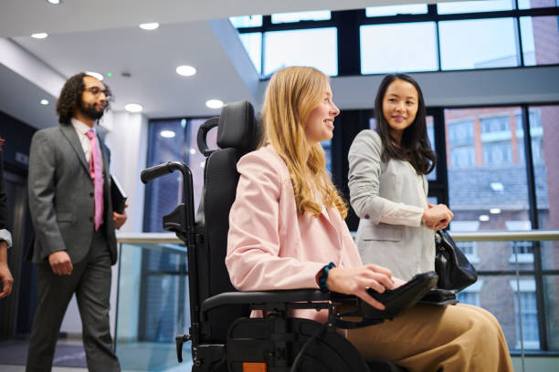 istock young woman with disability on her way to work with friends 2154432906