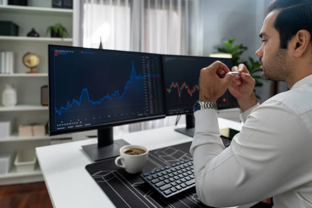 istock Trader analyzing in dynamic stock exchange investment screen on pc. Surmise. 2154434522