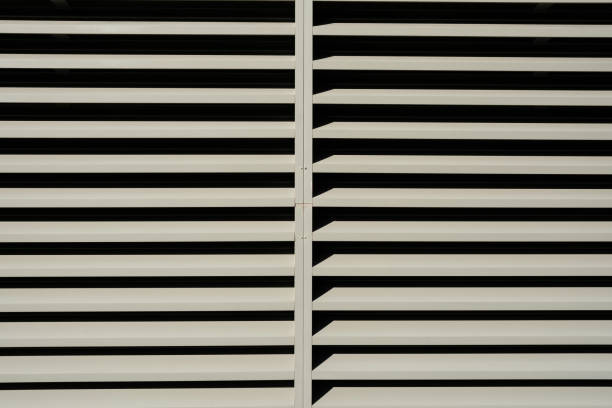 Close-up on gray metal vents to allow the passing of air.