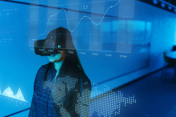istock Businesswoman using VR glasses and looking for augmented reality in the office 2154435735