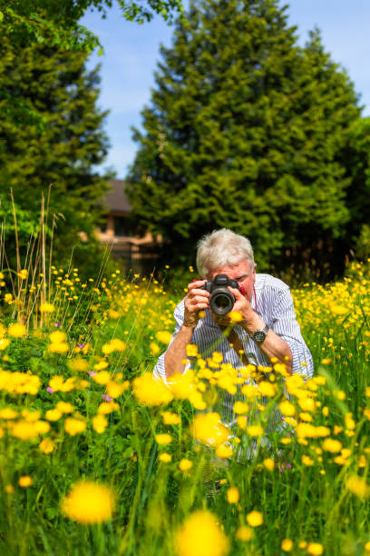 istock Happy senior man doing photography in nature 2154437525