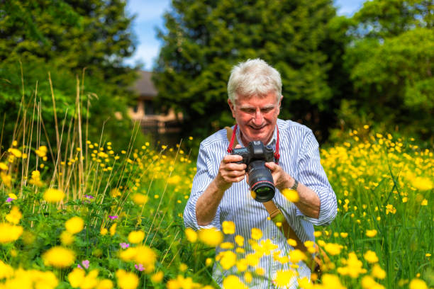 istock Happy senior man doing photography in nature 2154437575