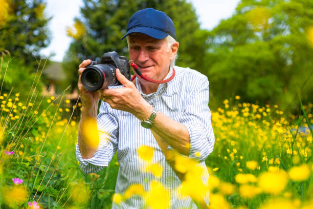 istock Happy senior man doing photography in nature 2154437597