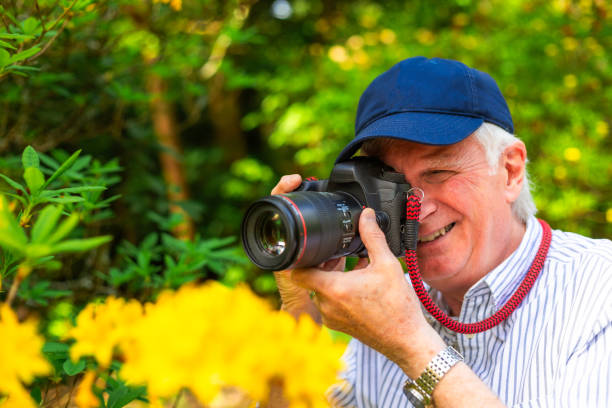 istock Happy senior man doing photography in nature 2154437670