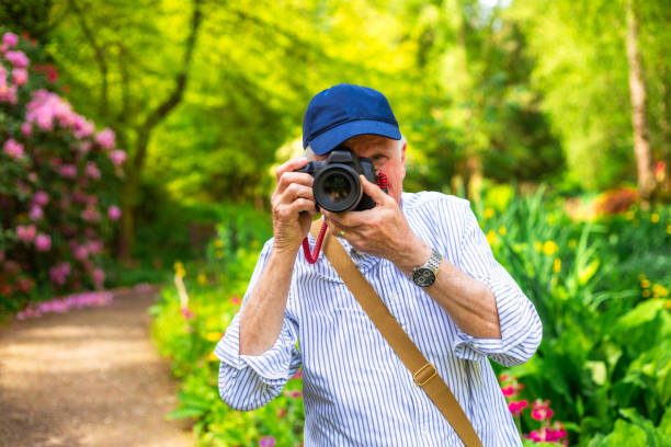 istock Happy senior man doing photography in nature 2154437695