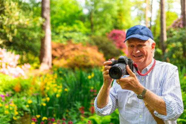 istock Happy senior man doing photography in nature 2154437733