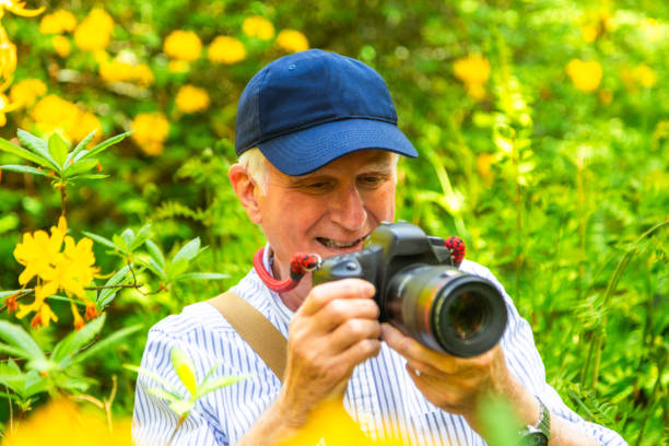 istock Happy senior man doing photography in nature 2154437782