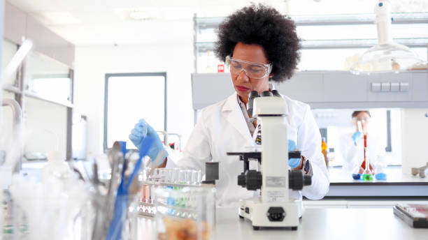 istock African American female scientist working on the microscope 2154437794