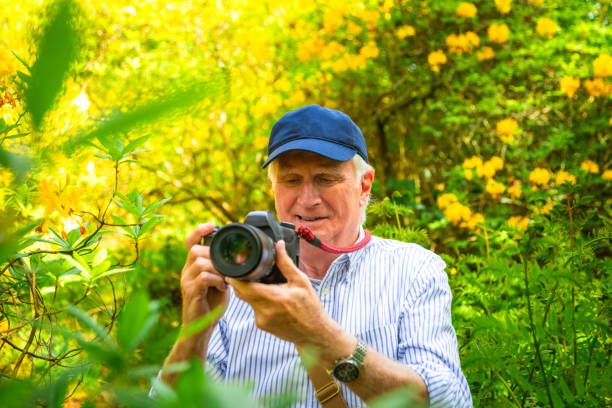 istock Happy senior man doing photography in nature 2154437861