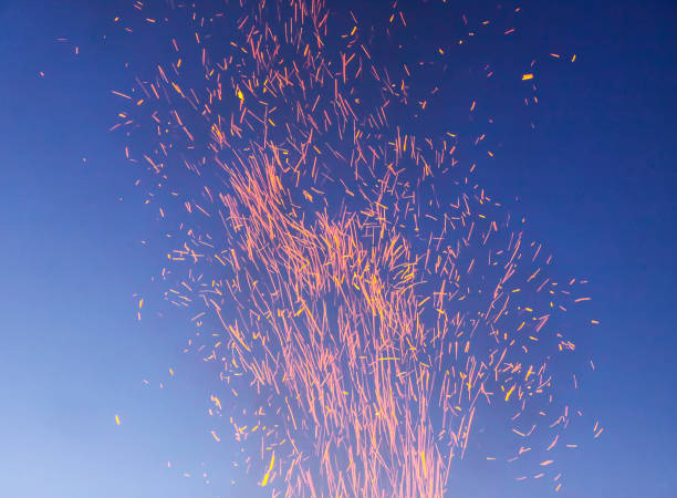 Bonfire sparkles on the night sky background.
