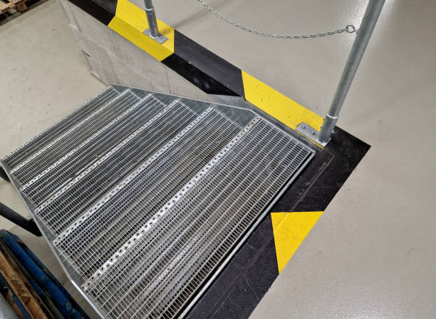 istock industrial hall, warehouse has a side door at a steep staircase with high resistance even under heavy load galvanized steel floor grate and railings. expanded metal, edges of stairs of safety yellow 2154441817