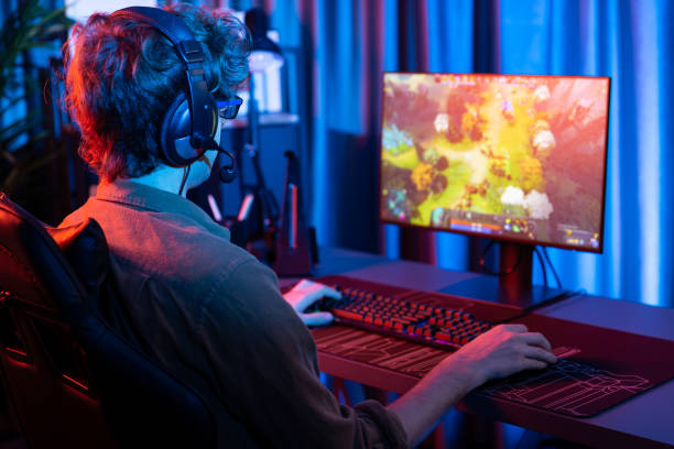 istock Young gaming streamer playing fighting Moba, wearing headphone and mic. Gusher. 2154441825