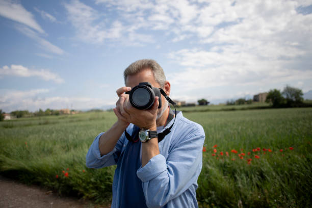 istock Older man taking pictures outdoors 2154443077