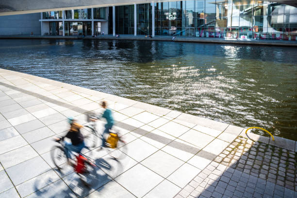 istock motion blurred cyclists in the modern government district at spree river 2154443220