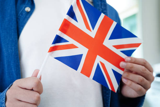 istock Learning English, Asian teenage student holding flag for language program education. 2154443646