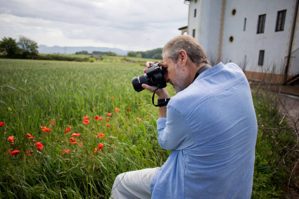 istock Older man taking pictures outdoors 2154447179