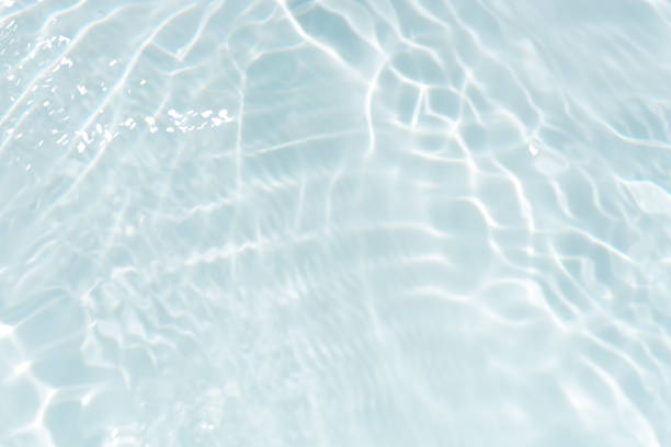 istock Blue water with ripples on the surface. Defocus blurred transparent blue colored clear calm water surface texture with splashes and bubbles. Water waves with shining pattern texture background. 2154450024