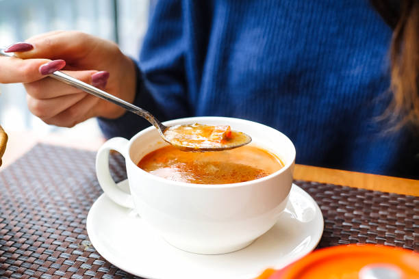 istock Woman Holding Spoon in Bowl of Soup 2154450077