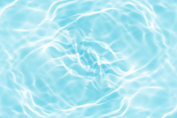 istock Blue water with ripples on the surface. Defocus blurred transparent blue colored clear calm water surface texture with splashes and bubbles. Water waves with shining pattern texture background. 2154450402
