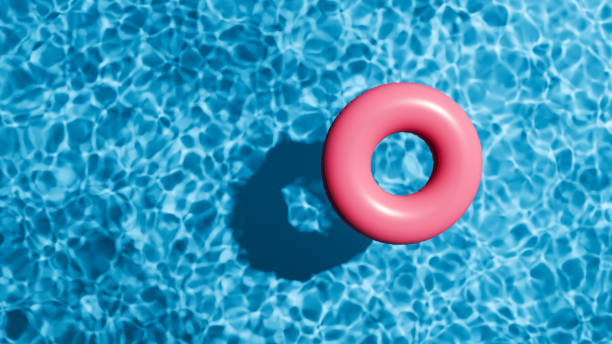 istock Summer holidays banner. Swimming pool top view. Red swimming ring in the empty clear pool. 2154450928