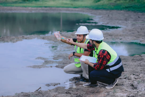 istock Environmental engineers work at wastewater treatment plants,Water supply engineering working at Water recycling plant for reuse,Technicians and engineers discuss work together 2154452165