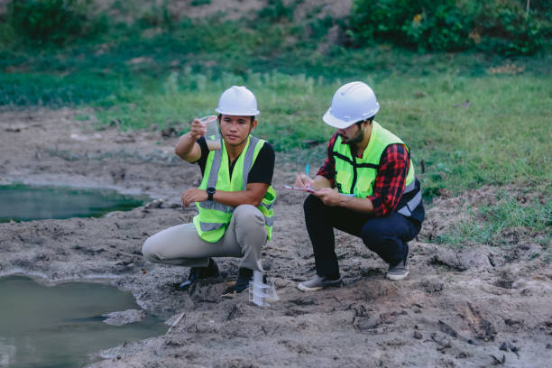 istock Environmental engineers work at wastewater treatment plants,Water supply engineering working at Water recycling plant for reuse,Technicians and engineers discuss work together 2154452166